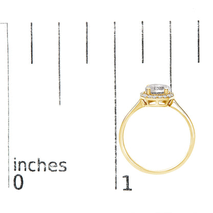 Yellow metal ring with a round white central gemstone set in four prongs, surrounded by smaller round white gemstones in a shared prong setting, shown on a scale with a side profile angle.