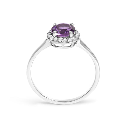 White metal ring shown from the side angle with a round purple gemstone in four-prong setting surrounded by a circle of small round white gemstones in shared prong setting.
