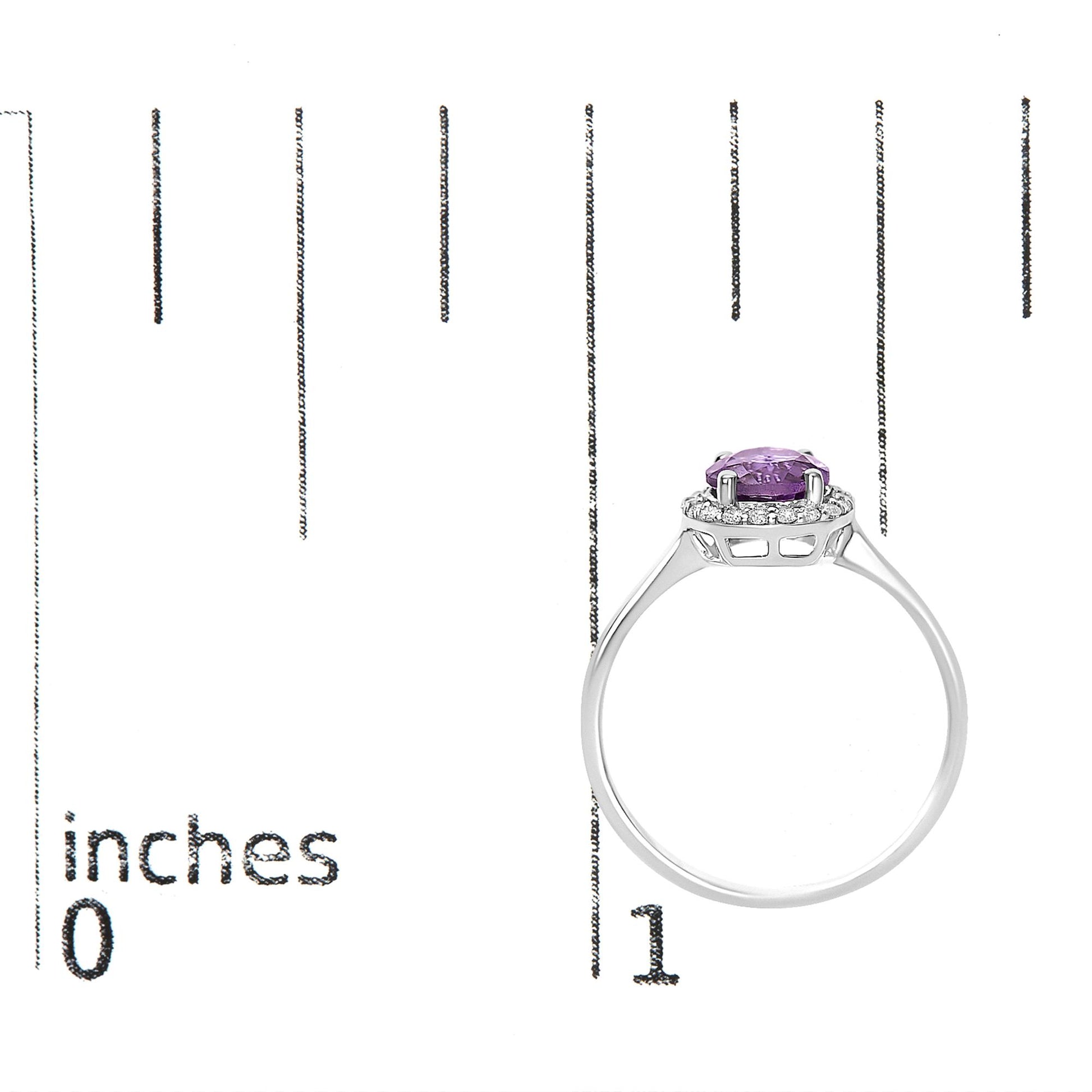 White metal ring with a round purple gemstone in a four-prong setting, surrounded by a halo of small white round gemstones in shared prong settings, shown on a scale from a side angle.