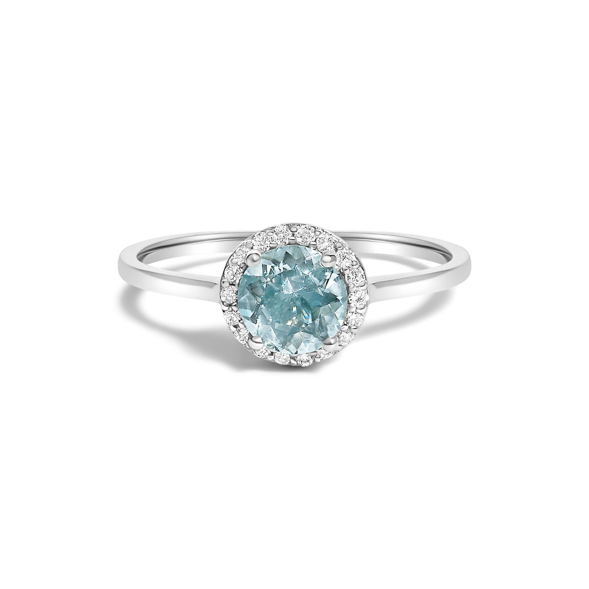 White metal ring with a round blue gemstone center set with four prongs, surrounded by a circle of small round white gemstones in a shared prong setting, shown in a front-facing angle on a white background.