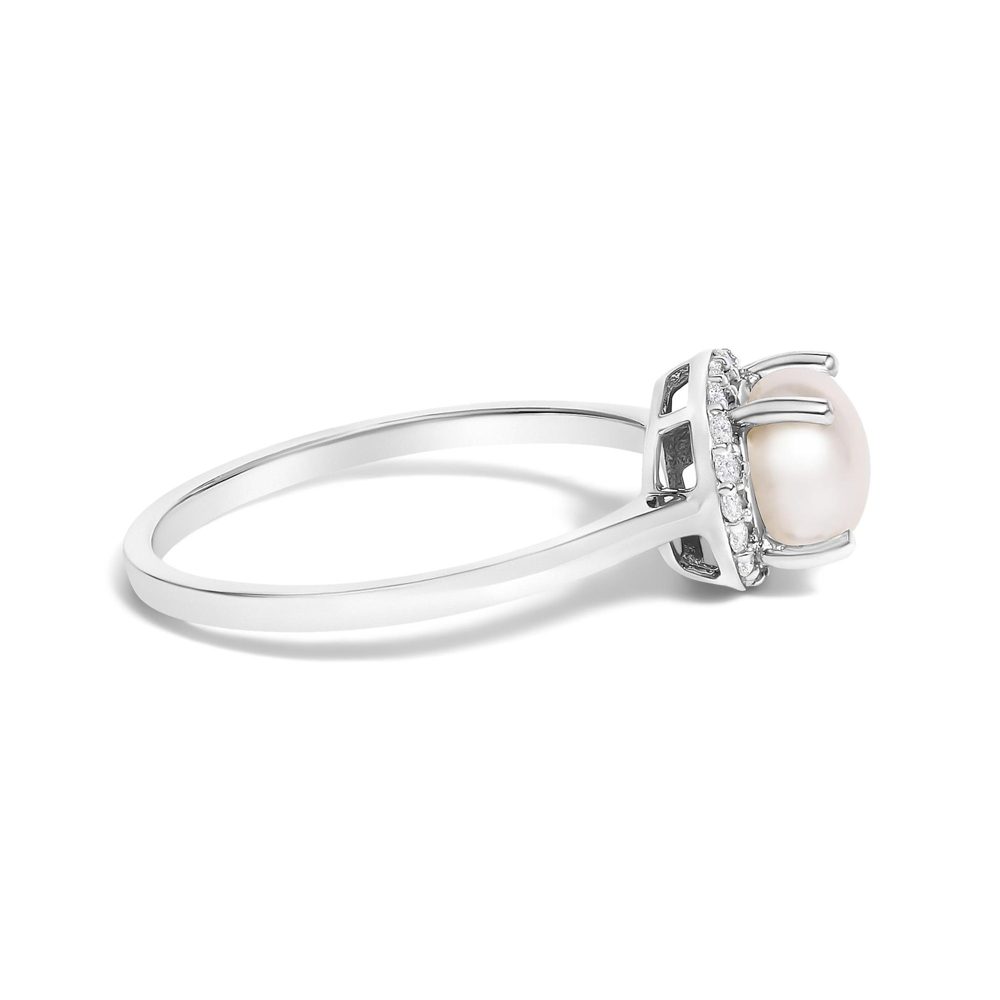 Side view of a white metal ring with a round center pearl and a halo of small white round gemstones in shared prong setting.