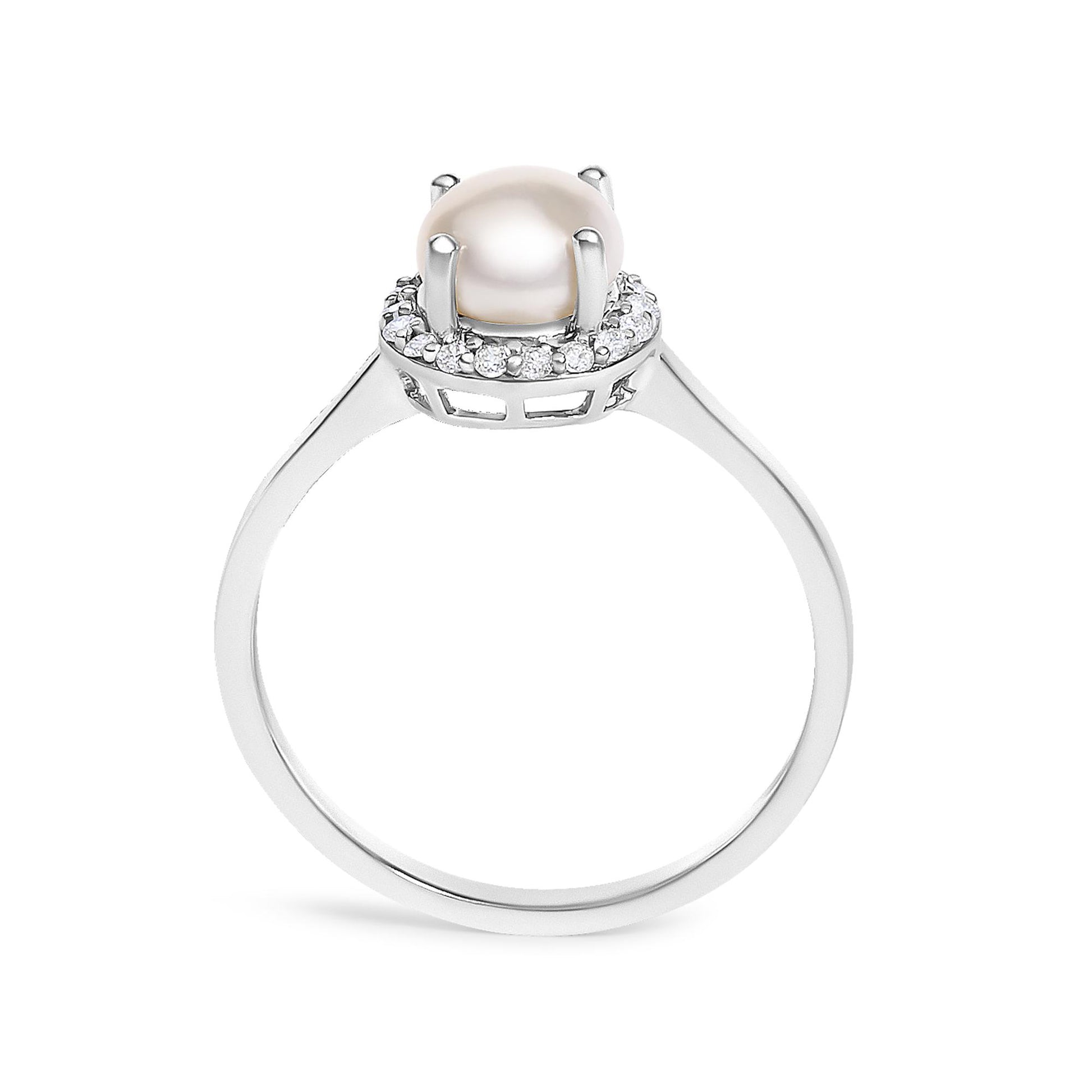 Close-up front angle of a white metal ring featuring a central round pearl held by four prongs, surrounded by a halo of small round white gemstones in a shared prong setting.