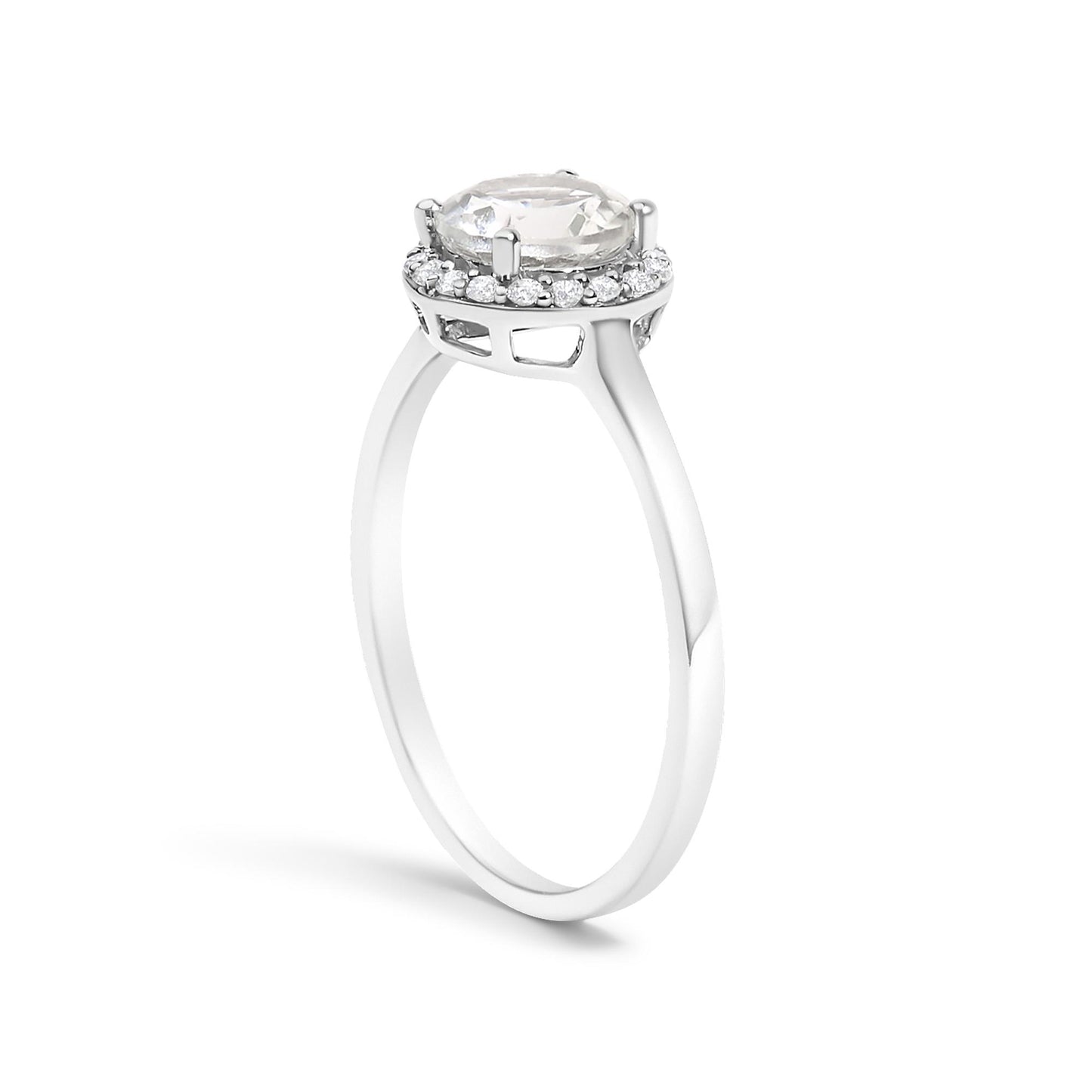White metal ring with a raised round white gemstone held by four prongs, surrounded by a halo of smaller round white gemstones in shared prong settings, shown from a side angle on a white background.