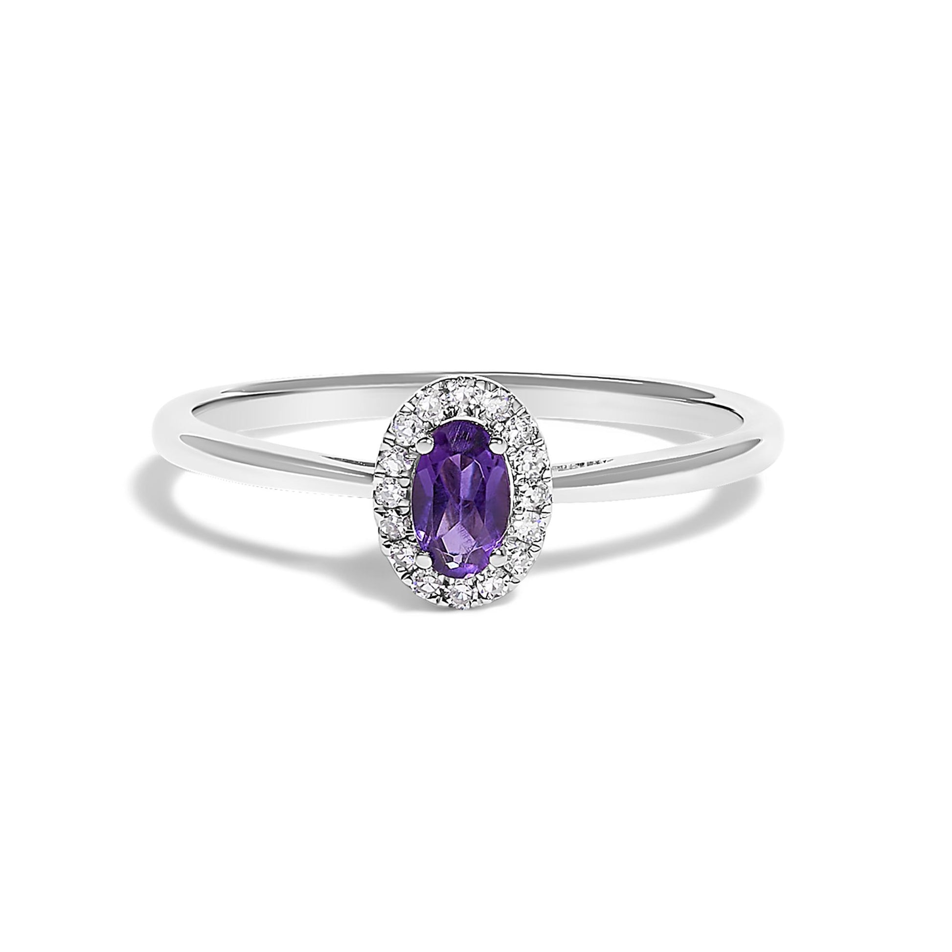 White metal ring with a central oval purple gemstone surrounded by small round white gemstones in a halo setting, shown from a front angle on a white background.