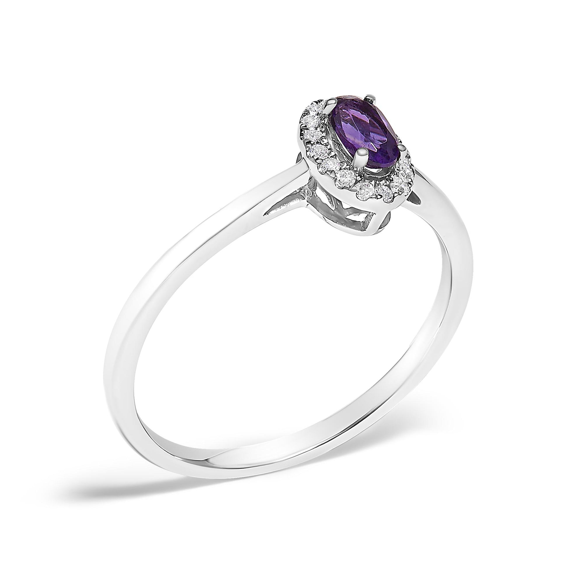 White metal ring shown at an angle with an oval purple gemstone in the center surrounded by small white gemstones in micro-pave setting.