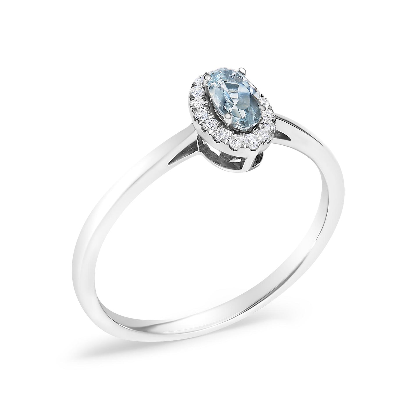 White metal ring shown at an angled top view with an oval blue gemstone in the center prong set, surrounded by a halo of small white round gemstones in micro-pave setting.