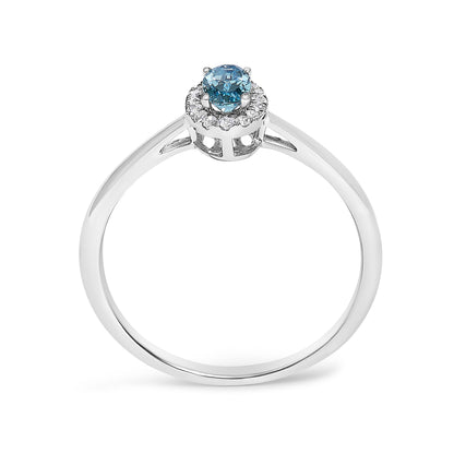White metal ring with a round blue gemstone in the center, surrounded by small white gemstones in a halo design, shown from a front angled view on a white background.