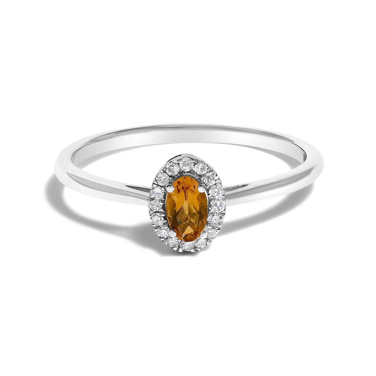 Close-up front view of a white metal ring featuring an oval orange gemstone in a prong setting, surrounded by round white gemstones in a micro-pave setting.