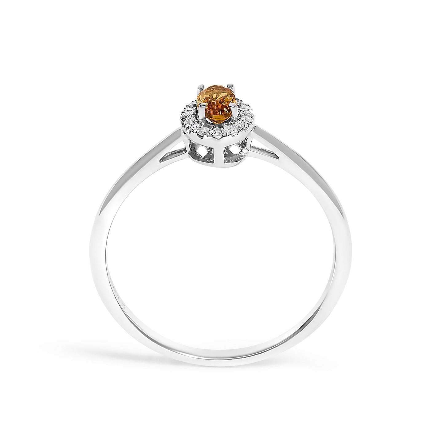 Top-front angled view of a white metal ring featuring a round orange gemstone in a prong setting, surrounded by a circle of small white gemstones in a micro-pave setting.
