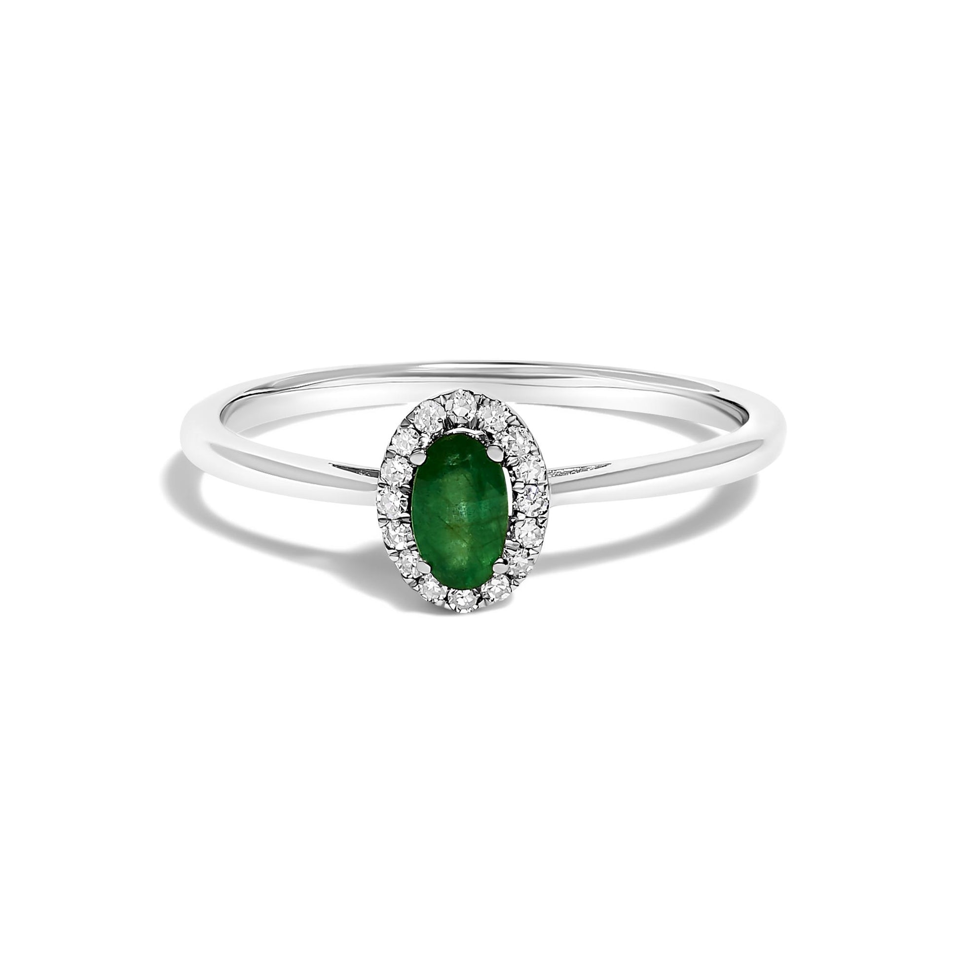 Front view of a white ring with an oval green gemstone in a prong setting, surrounded by a halo of small round white gemstones in a micro-pave setting.