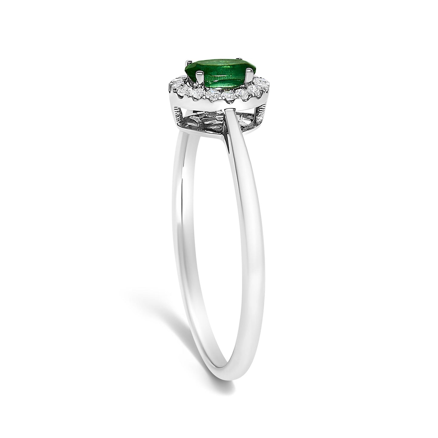 Side view of a white ring featuring an oval green gemstone in a prong setting, surrounded by a circle of small white round gemstones in a micro-pave setting.
