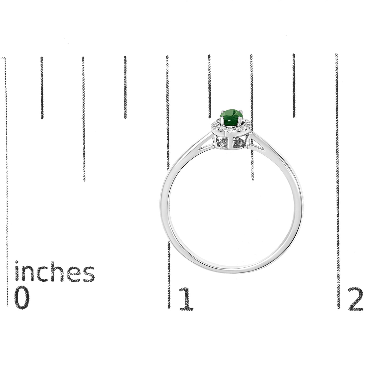 White ring with an oval green gemstone surrounded by small white gemstones in a micro-pave setting, shown on a scale from the side angle.