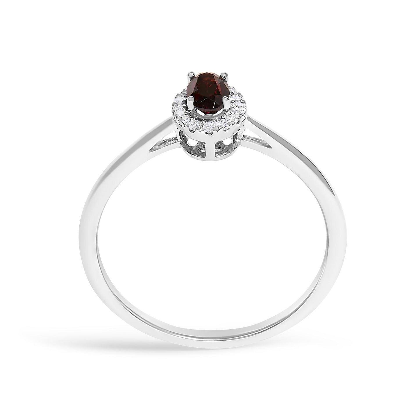 White metal ring shown from the top angle with an oval red gemstone in prong setting surrounded by round white gemstones in a micro-pave setting.