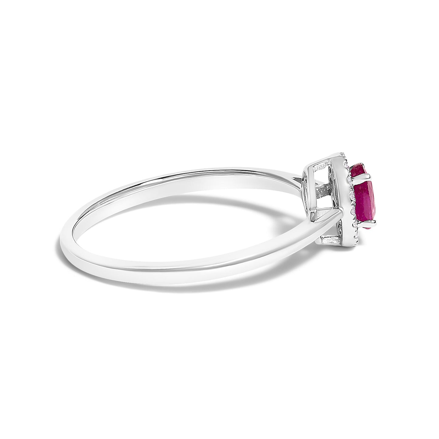 Side angle view of a white metal ring with a single oval red gemstone in a prong setting, surrounded by round white gemstones in a micro-pave setting.