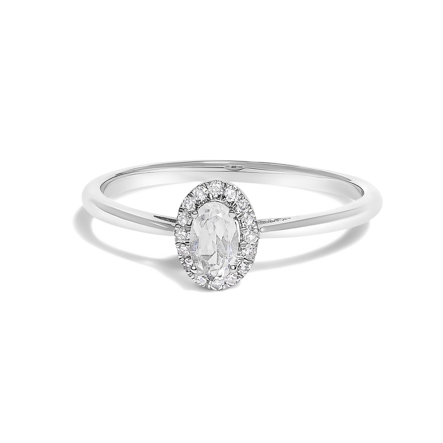 White metal ring with an oval-shaped white gemstone in a prong setting, surrounded by small round white gemstones in a micro-pave setting, shown in a front-facing angle.