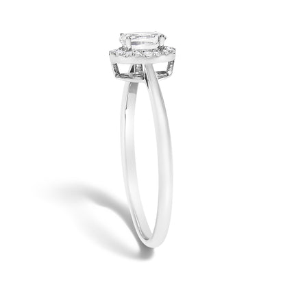 White metal ring with a thin band, featuring an oval white gemstone in a prong setting surrounded by small round white gemstones in a micro-pave setting, shown in a side profile angle.
