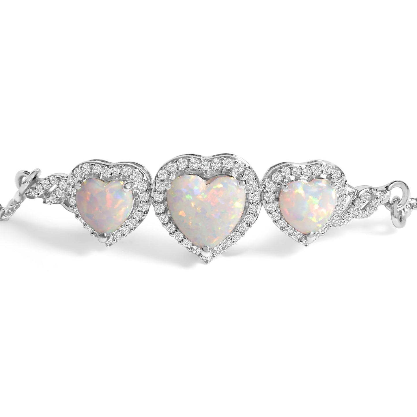 Close-up front view of a white metal bracelet featuring three heart-shaped white opal gemstones each surrounded by small round white gemstones in prong setting.