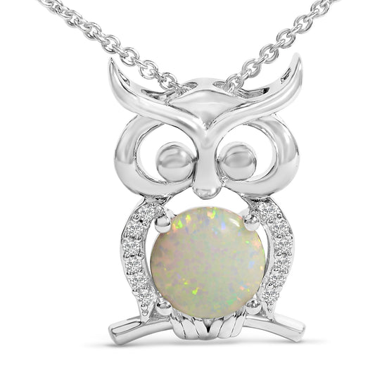 Close-up front angle of a white metal owl-shaped necklace pendant featuring a round white opal gemstone in the center and surrounded by multiple small white gemstones along the body, shown on a white background.
