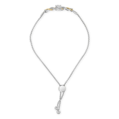 Bracelet shown against a white background, featuring a white chain with a sliding clasp and a section near the clasp in yellow and white metals adorned with a single round white gemstone in 4-prong setting and multiple smaller round white gemstones in prong settings, shot from a top down angle.