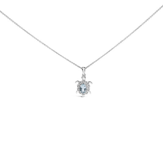 White metal necklace with turtle-shaped pendant featuring an oval blue gemstone at the center surrounded by round white gemstones, shown front-facing on a white background.