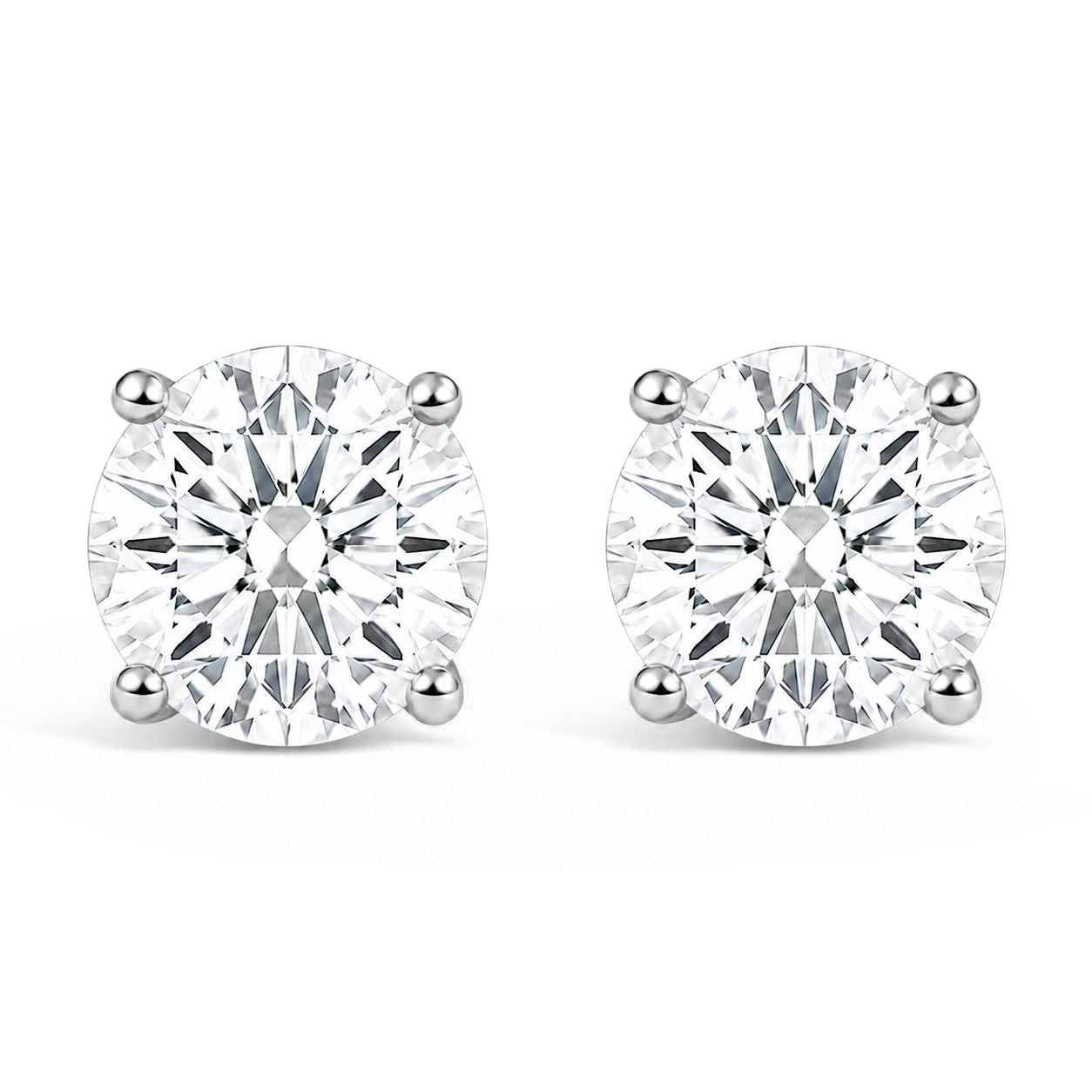Pair of white metal stud earrings with round white gemstones in 4-prong settings, shown in a front-facing angle on a white background.