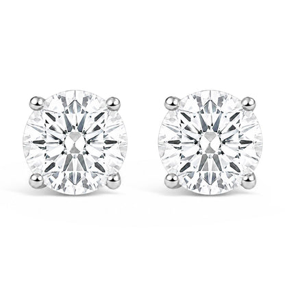 Pair of white metal stud earrings with round white gemstones in 4-prong settings, shown in a front-facing angle on a white background.