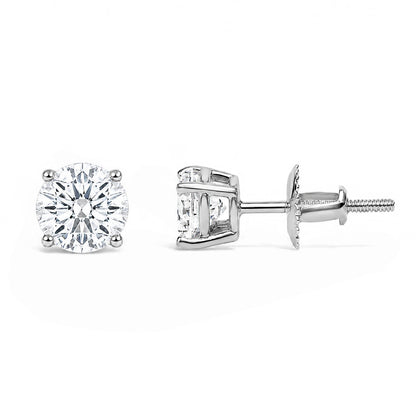 Front and side view close-up of a pair of white metal stud earrings each set with a round white gemstone in a four-prong setting, shown against a white background.
