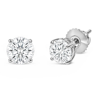 Close-up front and angled side view of white metal stud earrings with round white gemstones in four-prong settings shown on a white background.