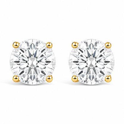 Pair of yellow metal stud earrings with round white gemstones in four-prong settings, shown from the front on a white background.