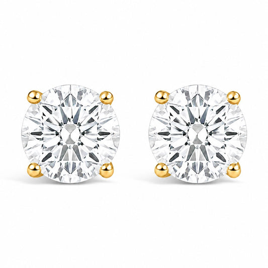 Pair of yellow metal stud earrings with round white gemstones in four-prong settings, shown from the front on a white background.