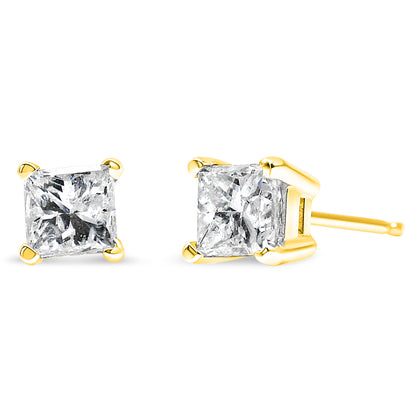 Pair of yellow metal stud earrings with princess-shaped white gemstones in four-prong settings, shown from front and side angles on a white background.