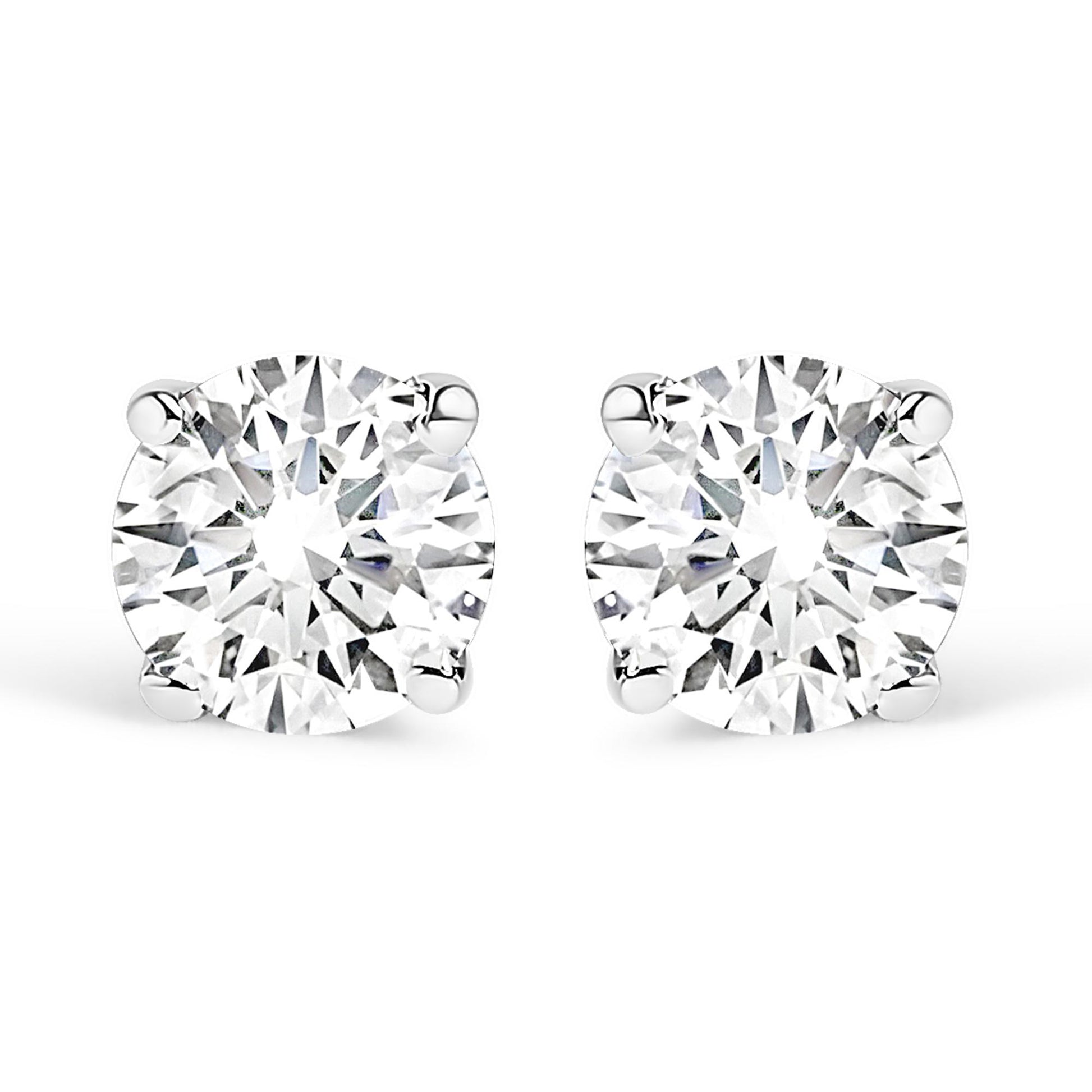 Front-facing close-up of a pair of white stud earrings each set with a round white gemstone in a four-prong setting.