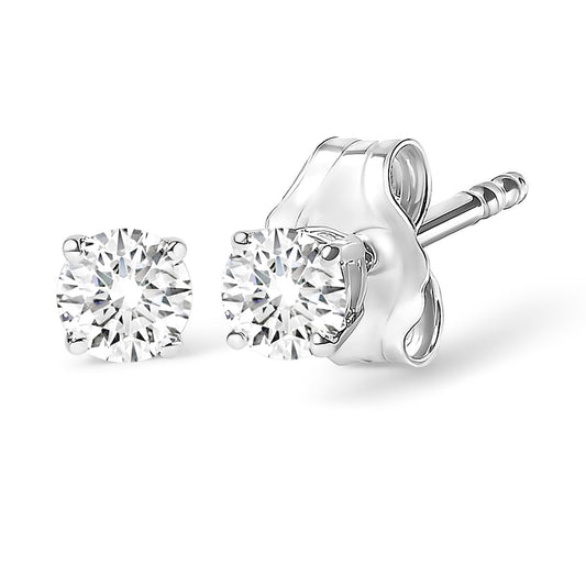 Close-up front and side angle of a pair of white metal stud earrings each set with one round white gemstone in a four-prong setting.
