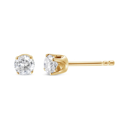 Close-up side and front view of yellow metal stud earring set with round white gemstones in four-prong settings.