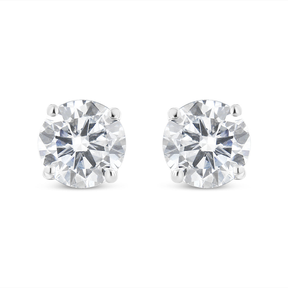 Pair of white metal stud earrings with round white gemstones in four-prong settings, front-facing angle.