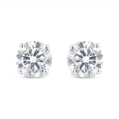 Pair of white metal stud earrings with round white gemstones in four-prong settings, front-facing angle.