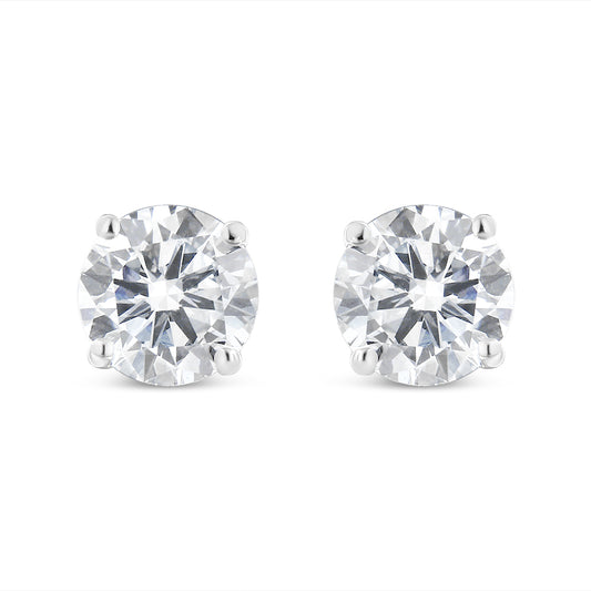 Pair of white metal stud earrings with round white gemstones in four-prong settings, front-facing angle.
