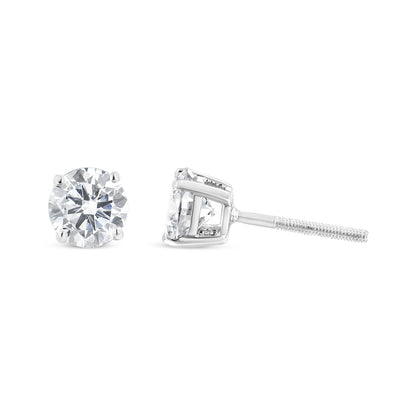 Pair of white metal stud earrings with round white gemstones in 4-prong settings, shown from front and side angles on a white background.