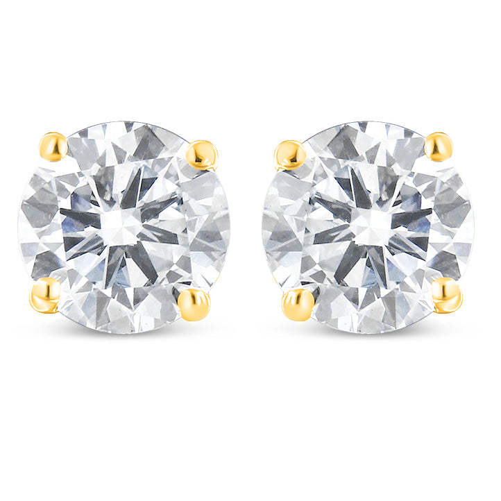 Front view of a pair of yellow metal stud earrings, each featuring a single round white gemstone in prong settings.