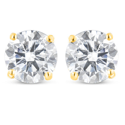 Front view of a pair of yellow metal stud earrings, each featuring a single round white gemstone in prong settings.