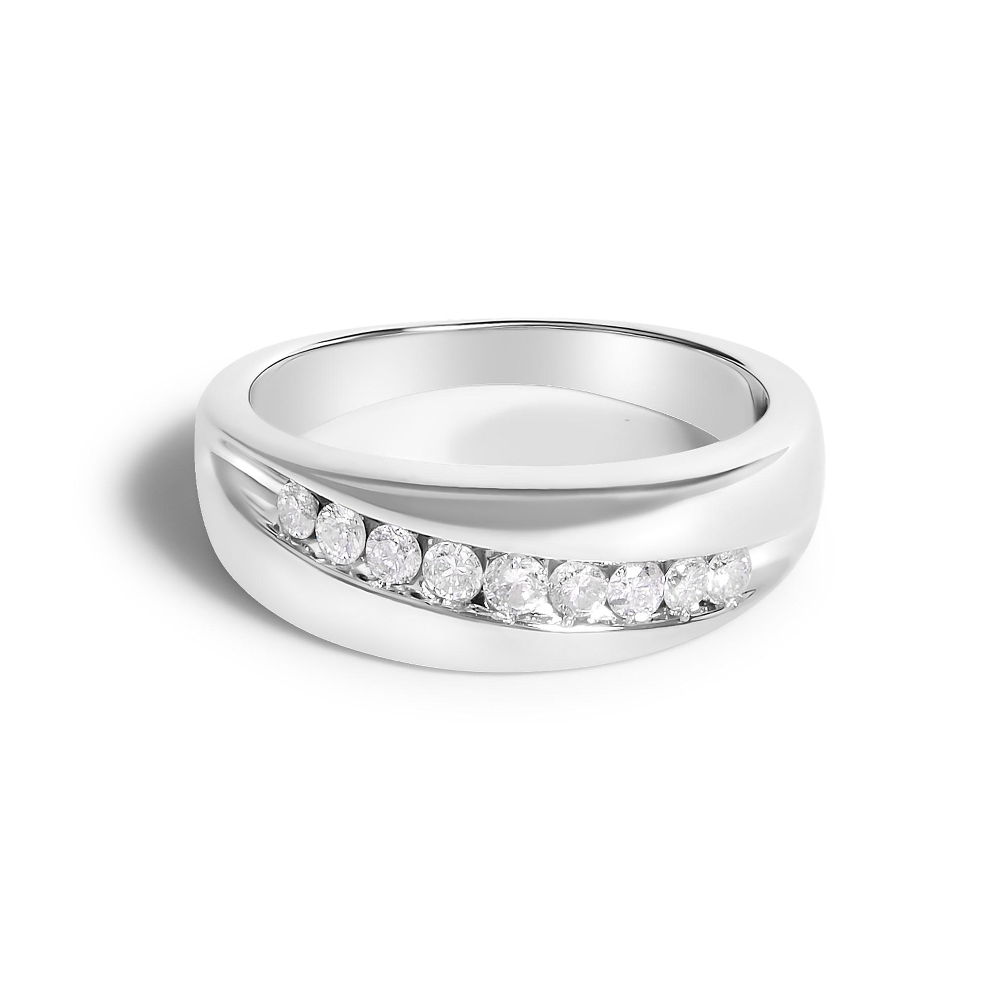 Close-up front angle of a white metal ring with a curved channel setting featuring nine round white gemstones.