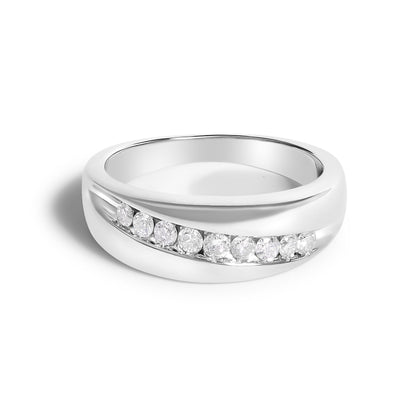 Close-up front angle of a white metal ring with a curved channel setting featuring nine round white gemstones.