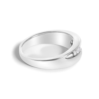 White ring with a smooth rounded band featuring a channel setting of round white gemstones, shown in a close-up angled view.