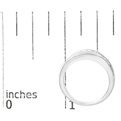 White metal ring with a row of round white gemstones set in a channel setting, shown from a top-down angle on a scale marked in inches.