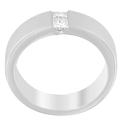 White metal ring with two princess shape white gemstones in a channel setting, top angle view.