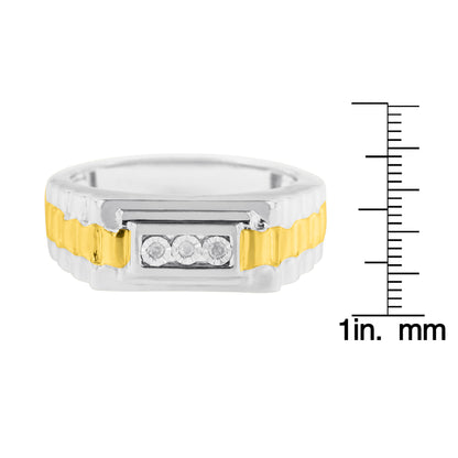 Front view of a two-toned ring with a yellow center band and white edges, set with three round white gemstones in a rectangular setting, shown next to a ruler for size reference.