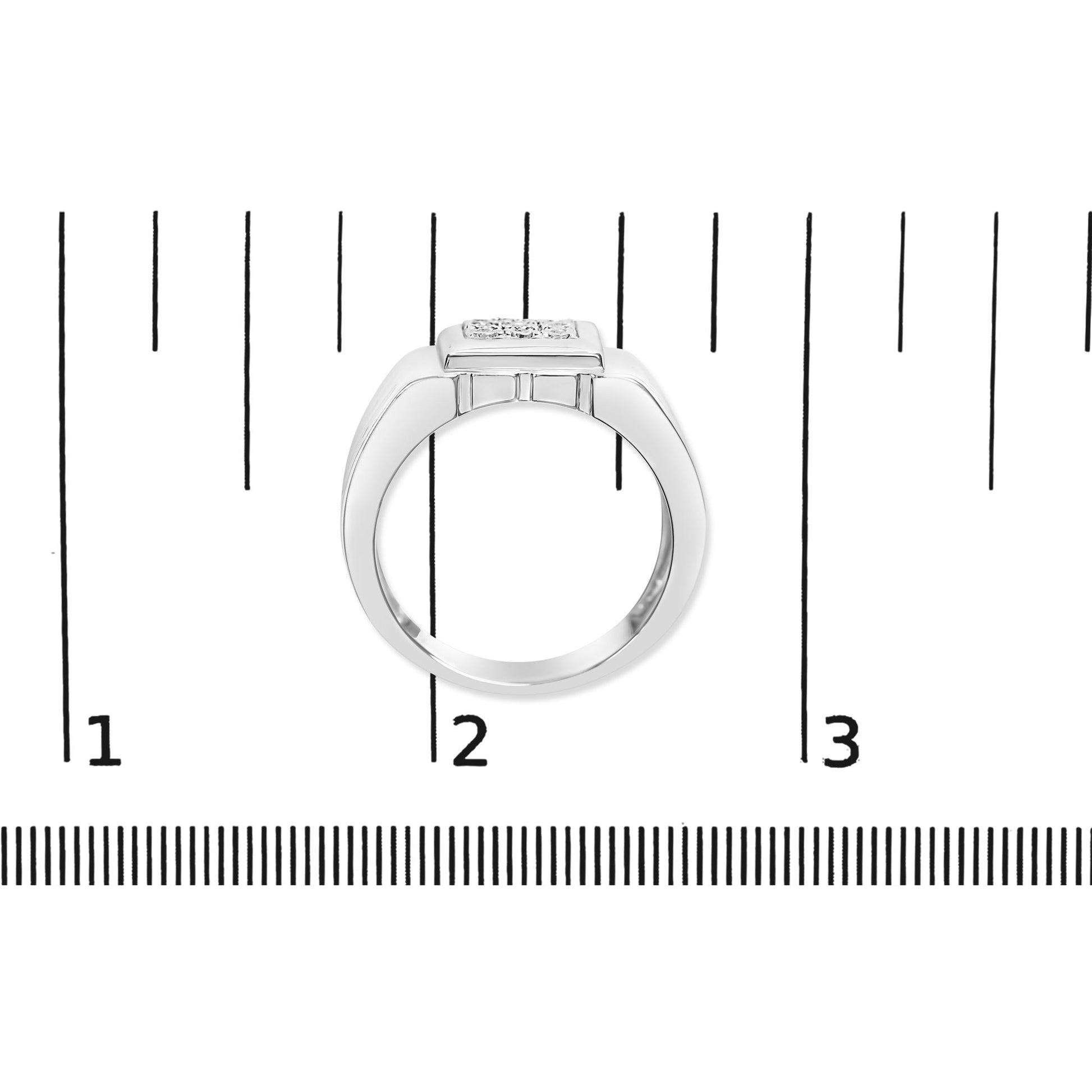 White metal ring with a flat, square top set with multiple round white gemstones in a miracle setting, shown from the side on a scale.