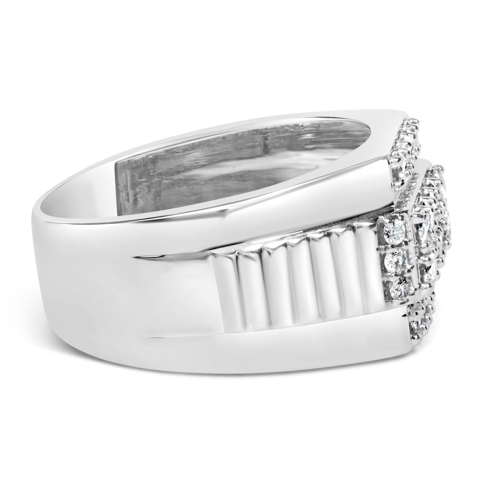 White metal ring with a wide band and several round white gemstones set in prong settings, shown from a side angle.