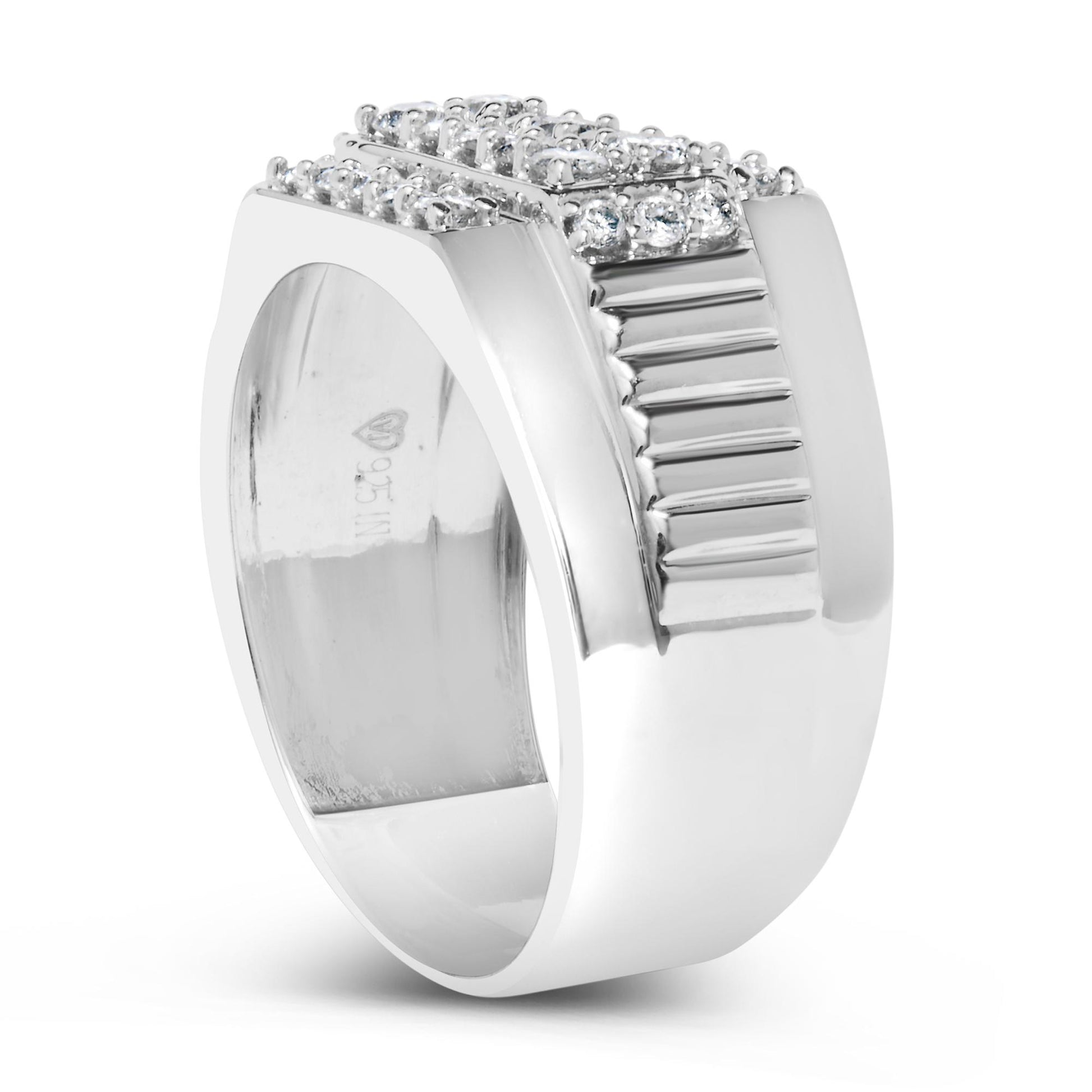 Close-up front-angle view of a wide white metal ring featuring a raised square cluster of round white gemstones in prong settings, with grooved detailing on one side.