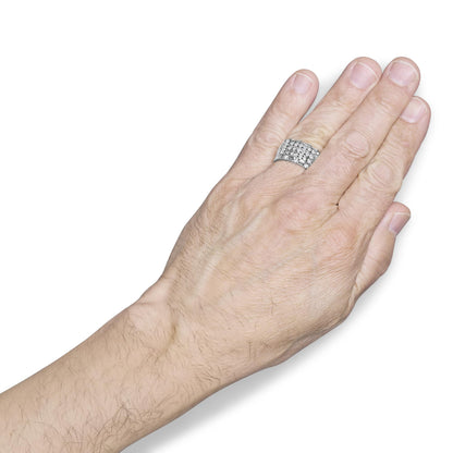 Close-up top view of a hand wearing a wide white metal ring with rows of round white gemstones in miracle and channel settings.